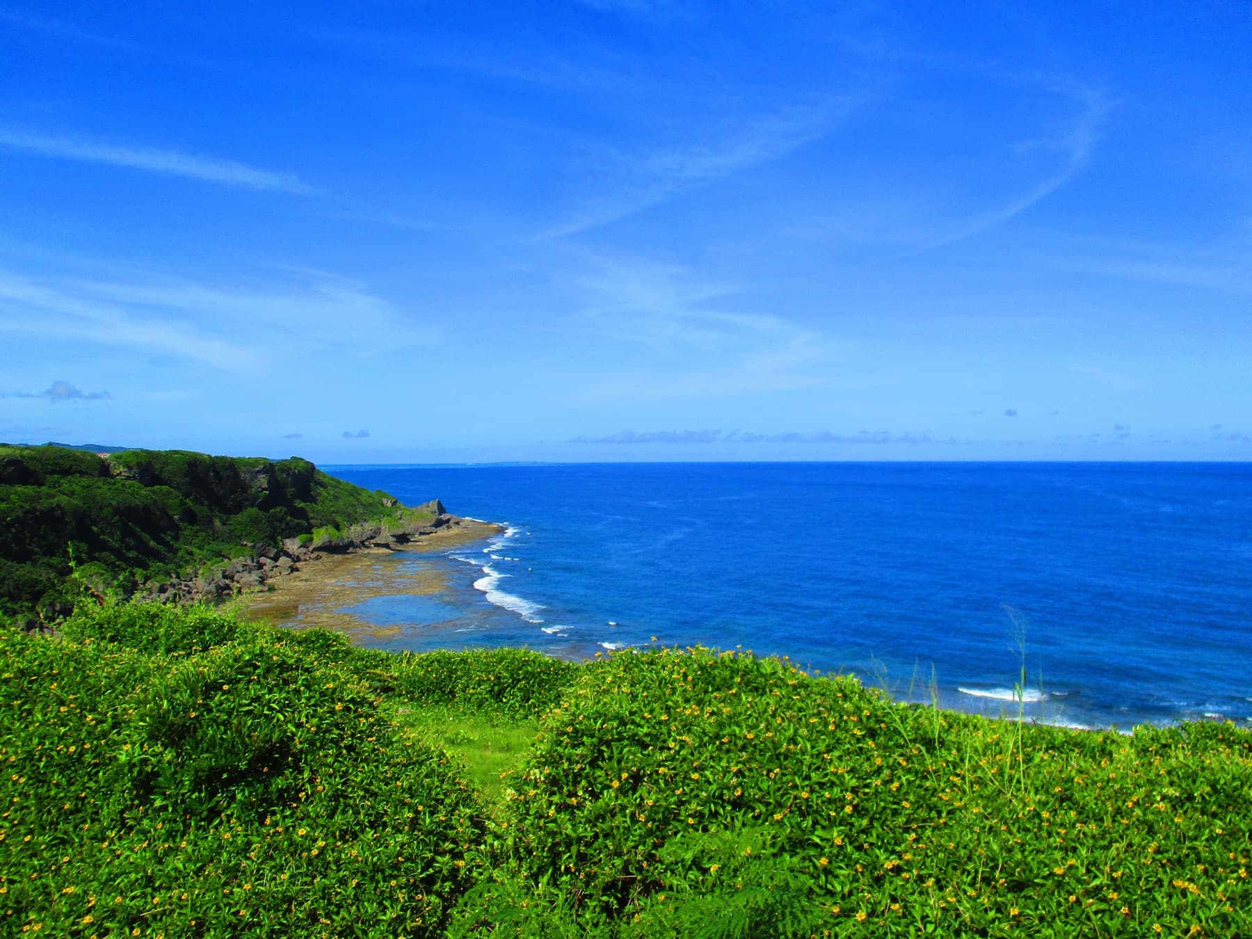 The blue ocean and green coastline at Mabuni Hill in Okinawa